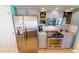 Updated kitchen with stainless steel appliances, gray cabinets, and tile backsplash at 10203 Windsong Rd, Punta Gorda, FL 33955