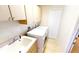 Bright laundry room features a utility sink, upper cabinets and appliances, ideal for convenient chores at 10203 Windsong Rd, Punta Gorda, FL 33955