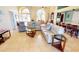 Open living space boasting tile floors, large windows, and comfortable furnishings at 10203 Windsong Rd, Punta Gorda, FL 33955