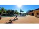Beautiful outdoor pool surrounded by lush landscaping and brick pavers on a sunny day at 10203 Windsong Rd, Punta Gorda, FL 33955