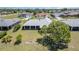 Aerial view of the home, showing the expansive backyard, mature tree, and neighborhood at 1069 Fergus Ln, Punta Gorda, FL 33983