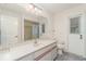 Well-lit bathroom featuring a walk-in shower, spacious countertop, and exterior door at 1069 Fergus Ln, Punta Gorda, FL 33983