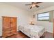 Bedroom featuring hardwood floors, a ceiling fan, a large window, and ample space at 1069 Fergus Ln, Punta Gorda, FL 33983