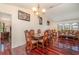 Spacious dining room featuring hardwood floors, elegant lighting, and access to the living room at 1069 Fergus Ln, Punta Gorda, FL 33983