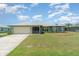 Charming single-story home featuring well-manicured landscaping and an attached two-car garage at 1069 Fergus Ln, Punta Gorda, FL 33983
