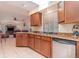 Bright kitchen featuring granite countertops, wood cabinets, and an open view to the living area at 1069 Fergus Ln, Punta Gorda, FL 33983