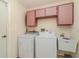Functional laundry room with a washer, dryer, utility sink, and overhead cabinets at 1069 Fergus Ln, Punta Gorda, FL 33983