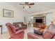 Inviting living room with plush seating, a ceiling fan, and a decorative entertainment center at 1069 Fergus Ln, Punta Gorda, FL 33983