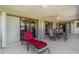 Inviting covered patio with tile floors, ceiling fans, lounge chair, and outdoor seating area at 1069 Fergus Ln, Punta Gorda, FL 33983