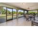 Enclosed patio with tile flooring, outdoor furniture, and views of the backyard at 1069 Fergus Ln, Punta Gorda, FL 33983