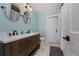 Well-lit bathroom with a double sink vanity, modern fixtures, and a separate toilet room at 12420 Minot Ave, Port Charlotte, FL 33981