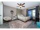 Cozy bedroom with unique decor, plush rug, ceiling fan, and sliding glass doors leading to the outdoors at 12420 Minot Ave, Port Charlotte, FL 33981