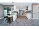 Beautiful kitchen featuring white cabinets, stainless steel appliances, wood flooring, and an island with bar stool seating at 12420 Minot Ave, Port Charlotte, FL 33981