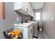 This laundry room features a utility sink, washer and dryer, and storage cabinets at 12420 Minot Ave, Port Charlotte, FL 33981