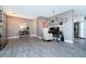 An office space with a table, chair, and wall decor is placed alongside the dining area at 12420 Minot Ave, Port Charlotte, FL 33981