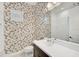 Charming bathroom featuring vibrant bird-themed wallpaper, a modern vanity, and tiled walls in the shower at 12472 Davie Ct, Venice, FL 34293