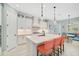 Bright kitchen boasts an island with seating, stainless steel appliances, and pendant lighting at 12472 Davie Ct, Venice, FL 34293