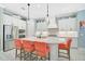 Modern kitchen features stainless steel appliances, ample cabinet space, and a center island with seating at 12472 Davie Ct, Venice, FL 34293