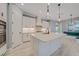 Stylish kitchen includes a central island, custom cabinetry, and high-end appliances at 12472 Davie Ct, Venice, FL 34293