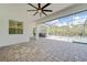 This expansive lanai includes pavers, a ceiling fan, and easy access to the pool and outdoor kitchen at 12472 Davie Ct, Venice, FL 34293
