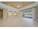 Bright living area with an open floor plan and sliding doors leading to an outdoor pool and patio at 12472 Davie Ct, Venice, FL 34293