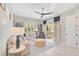 Bright living room with stylish furnishings, a ceiling fan, and sliding glass doors leading to the lanai at 12472 Davie Ct, Venice, FL 34293