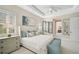 Serene main bedroom with tray ceiling, sitting area, and ensuite bathroom at 12472 Davie Ct, Venice, FL 34293