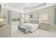 Elegant main bedroom features a tray ceiling, neutral colors, and plenty of natural light at 12472 Davie Ct, Venice, FL 34293
