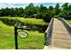 Wooden bridge offers stunning community views over a pond leading to Lookout Point Island at 12656 Sagewood Dr, Venice, FL 34293