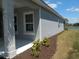 Charming home exterior with a well-maintained lawn and view of the lake at 12656 Sagewood Dr, Venice, FL 34293