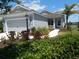 Charming single-story home with a manicured lawn, featuring a two-car garage and a welcoming front porch at 12656 Sagewood Dr, Venice, FL 34293