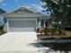 Charming single-Gathering home boasts a well-manicured lawn, two-car garage, and cozy front porch at 12656 Sagewood Dr, Venice, FL 34293