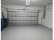 Spacious two-car garage with an automatic door offering secure parking and storage at 12656 Sagewood Dr, Venice, FL 34293