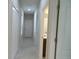 Bright hallway boasts tile floors, with doors to rooms and a closet for easy access at 12656 Sagewood Dr, Venice, FL 34293
