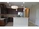 Stylish kitchen with dark cabinetry, stainless steel appliances, and a breakfast bar, perfect for entertaining at 12656 Sagewood Dr, Venice, FL 34293