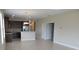 Modern kitchen with dark wood cabinets, stainless steel appliances, and an open layout to the living area at 12656 Sagewood Dr, Venice, FL 34293