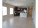Open floor plan with a kitchen featuring dark cabinets, stainless steel appliances, and a center island at 12656 Sagewood Dr, Venice, FL 34293
