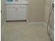 Clean laundry area with white cabinets, tile flooring, and washer hookups at 12656 Sagewood Dr, Venice, FL 34293