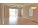 Spacious living room with tile floors, recessed lighting, and sliding glass doors that lead to the backyard at 12656 Sagewood Dr, Venice, FL 34293