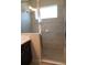 Modern shower featuring tiled walls, glass doors, and a built in soap dish at 12656 Sagewood Dr, Venice, FL 34293