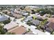 An aerial view showcases the home on a corner lot with a well manicured yard and lush tropical landscaping at 1677 Palace Ct, Punta Gorda, FL 33980