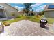 Lovely backyard with brick pavers, a grill, and lush landscaping at 1677 Palace Ct, Punta Gorda, FL 33980