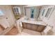 Elegant bathroom featuring double sinks, a granite countertop, and stylish wallpaper at 1677 Palace Ct, Punta Gorda, FL 33980