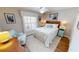Inviting bedroom with hardwood floors, a cozy chair, and a ceiling fan at 1677 Palace Ct, Punta Gorda, FL 33980