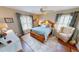 Charming bedroom with hardwood floors, a ceiling fan, and two windows at 1677 Palace Ct, Punta Gorda, FL 33980