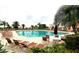 The community pool features plenty of seating and lush tropical landscaping at 1677 Palace Ct, Punta Gorda, FL 33980