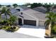 Charming single-story home with a three-car garage and tropical landscaping in a sunny neighborhood at 1677 Palace Ct, Punta Gorda, FL 33980
