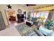 Open-concept living room featuring comfortable seating, large TV, and easy access to lanai at 1677 Palace Ct, Punta Gorda, FL 33980