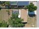 Aerial view of a cozy home with a screened-in pool and a well-maintained yard at 18459 Inwood Ave, Port Charlotte, FL 33948