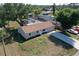 Aerial view of a home featuring a well-manicured lawn and a long driveway at 18459 Inwood Ave, Port Charlotte, FL 33948